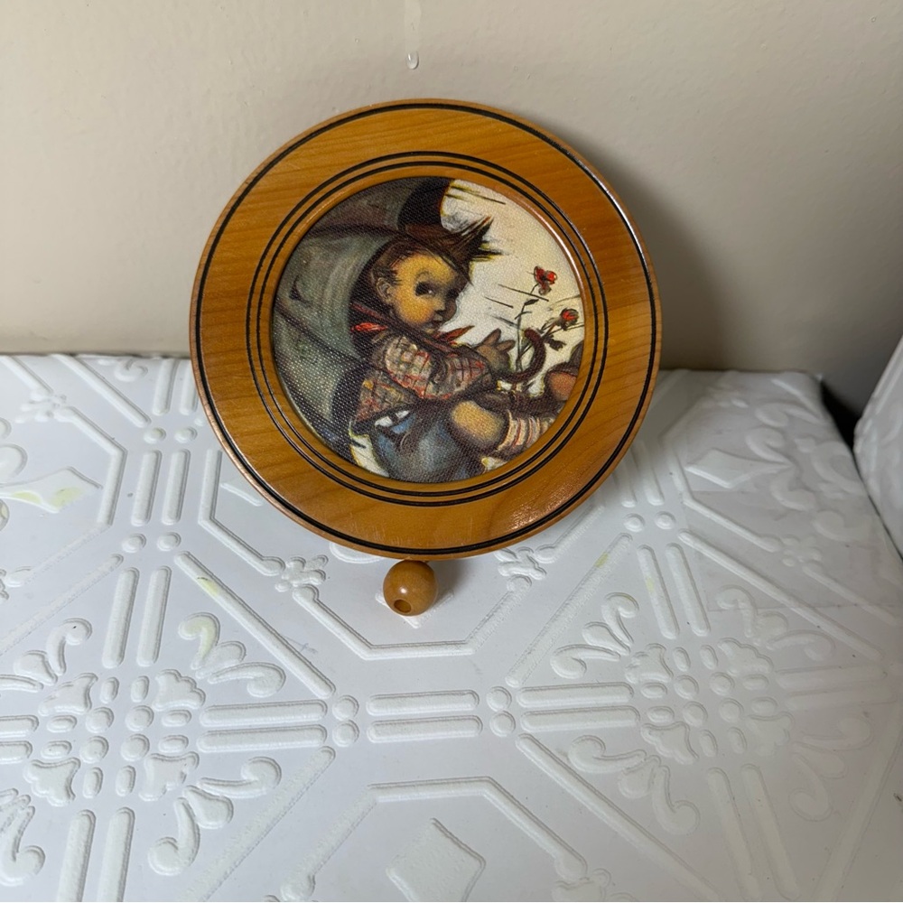 vintage Reuge musical wall plaque featuring a Hummel art image.